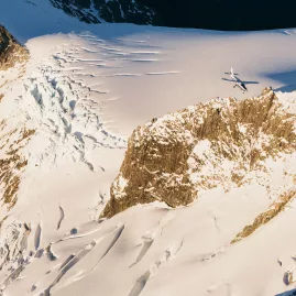 Plane from True South flying over crevassed glacier in New Zealand