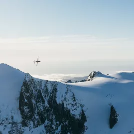 Scenic flight over snowy peaks in the Southern Alps with True South