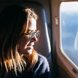 Woman enjoying scenic views from a True South Flights aircraft window