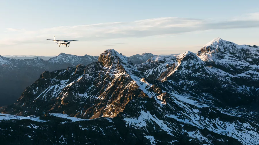 True South aircraft flying above jagged snowy Southern Alps mountain range