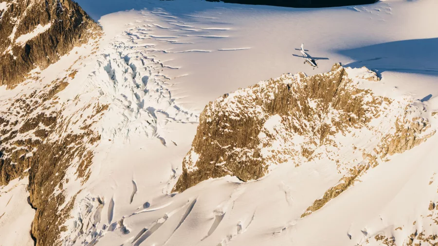 Plane from True South flying over crevassed glacier in New Zealand