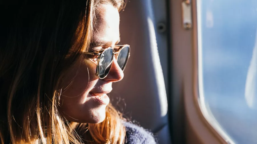Woman enjoying scenic views from a True South Flights aircraft window