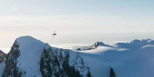 Scenic flight over snowy peaks in the Southern Alps with True South