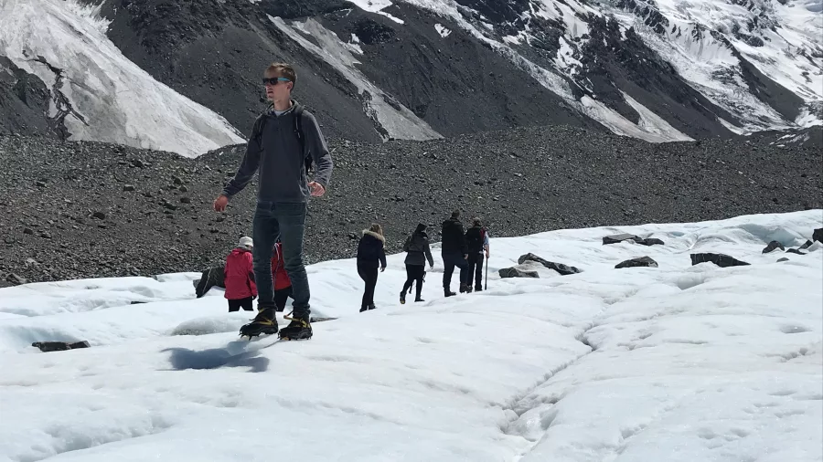 Visitors hiking across the Tasman Glacier ice field during a guided helihike near Mount Cook