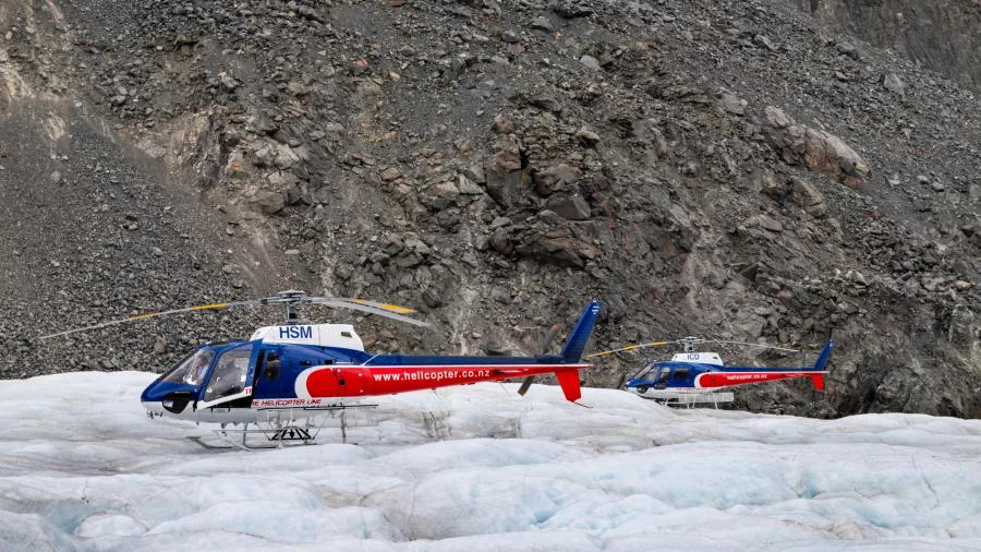 Twin helicopters parked on the Tasman Glacier ice field near Mount Cook