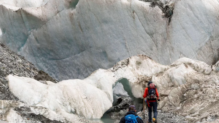 Group hiking the moraine zone at the edge of the Tasman Glacier