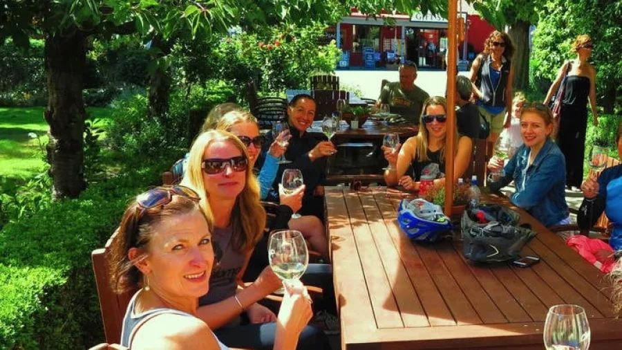Group of women enjoying a wine tasting at Gibbston Valley Wines’ outdoor patio