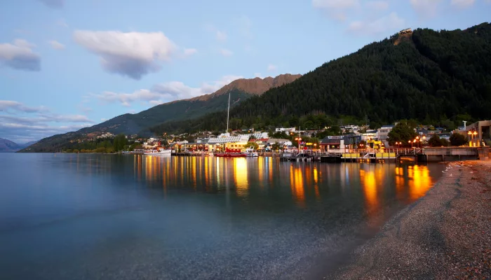 Steamer Wharf and Queenstown Bay at dusk with lights reflecting on Lake Wakatipu