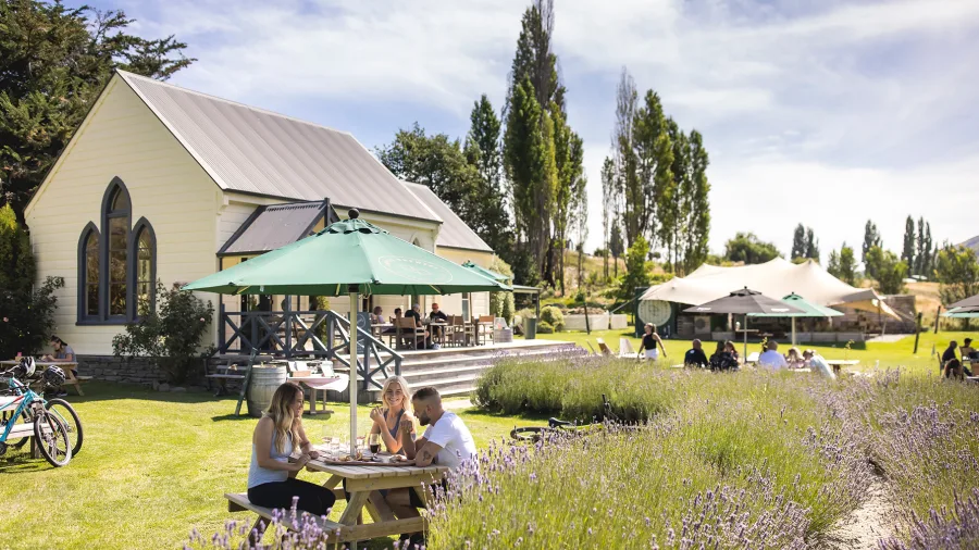 Group enjoying food and drinks in the garden at Cargo Brewery’s Apres Bike in Queenstown