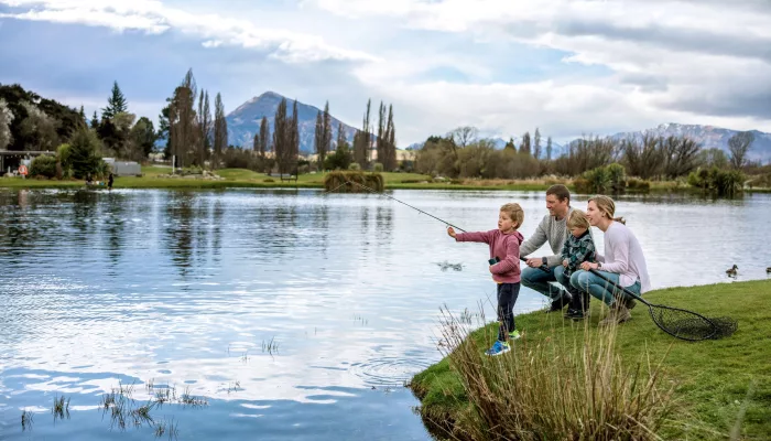 Family with young children fishing at Hooked on Lake Wānaka in Otago