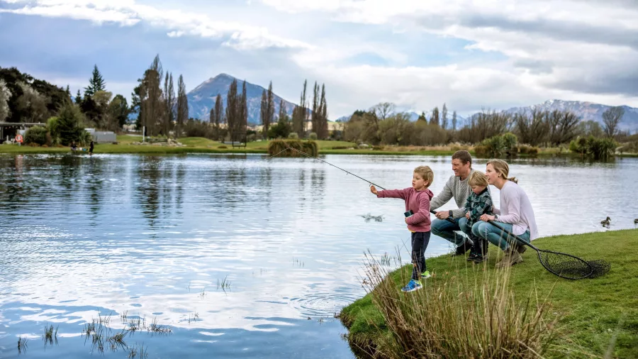 Family with young children fishing at Hooked on Lake Wānaka in Otago