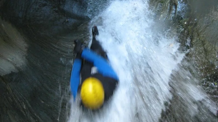 Fast slide descent down a natural water chute in the Niger Stream canyon.