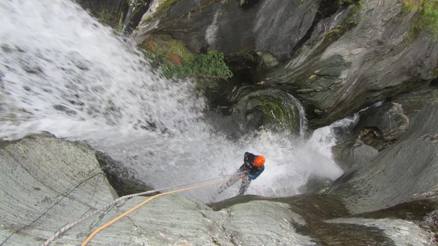 Canyoner abseiling down a steep waterfall in Big Nige Canyon near Wānaka.