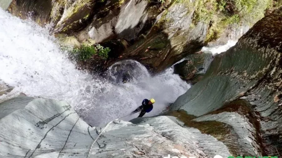Steep canyoning descent in Big Nige with Deep Canyon near Wānaka, featuring dramatic schist walls.