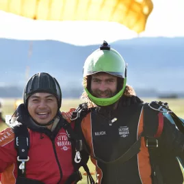Happy skydiver and instructor posing after a tandem jump with Skydive Wanaka