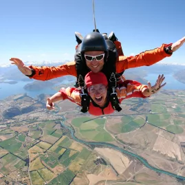 Skydivers freefalling above Wanaka’s patchwork farmland and lakes