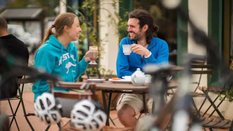 Cyclists enjoying coffee at a café in Wanaka