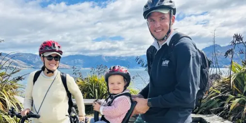 Family riding e-bikes on Wanaka Hawea lakeside trail
