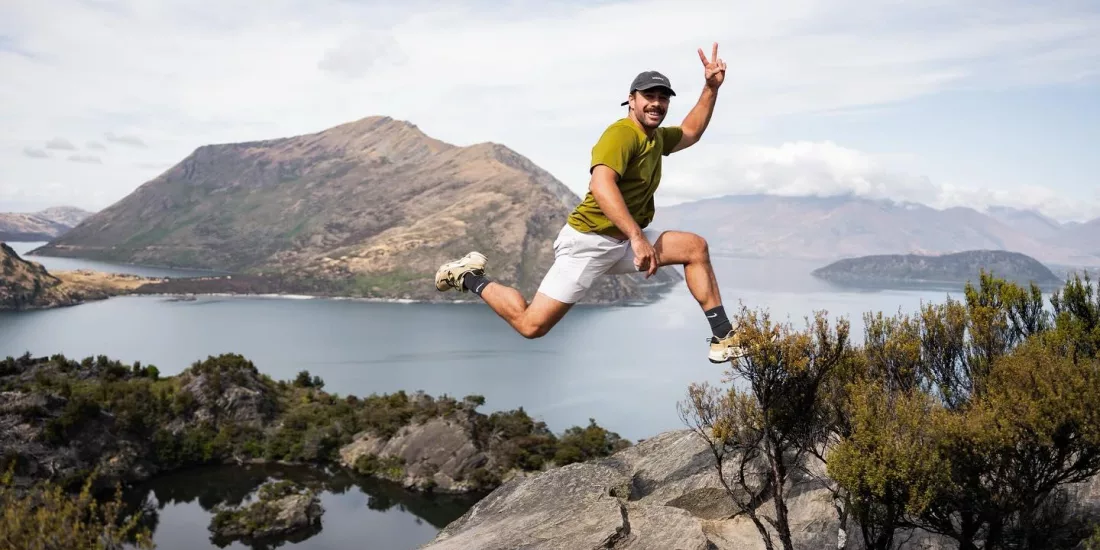 Person jumping joyfully on Mou Waho overlook