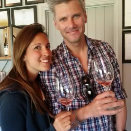 Couple enjoying rosé wine inside a boutique cellar door in Central Otago.