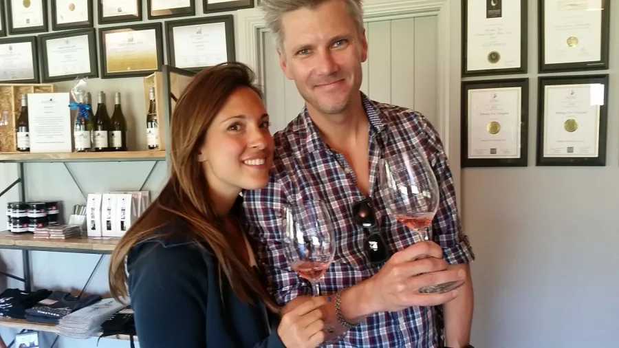 Couple enjoying rosé wine inside a boutique cellar door in Central Otago.
