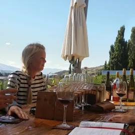 Visitors enjoying wine tasting at Bannock Brae Vineyard with views over Central Otago.