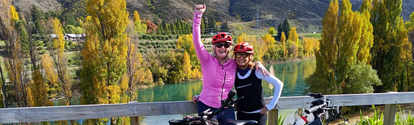 Two women celebrating at the end of the Lake Dunstan Trail near Clyde.