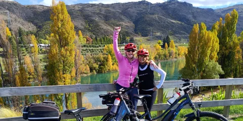 Two women celebrating at the end of the Lake Dunstan Trail near Clyde.