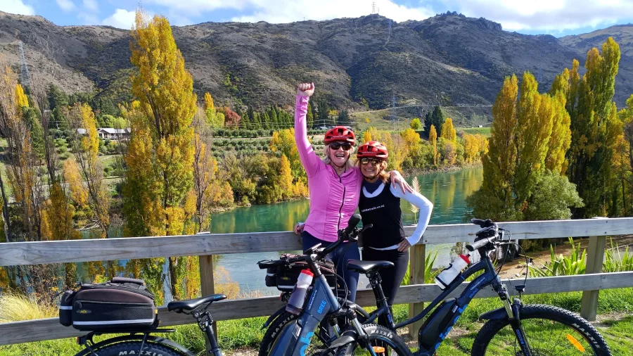 Two women celebrating at the end of the Lake Dunstan Trail near Clyde.