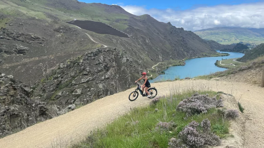 E-bike rider at the highest point of the Lake Dunstan Trail overlooking the lake.
