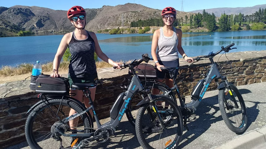 Two cyclists at the Cromwell start point of the Lake Dunstan Trail.