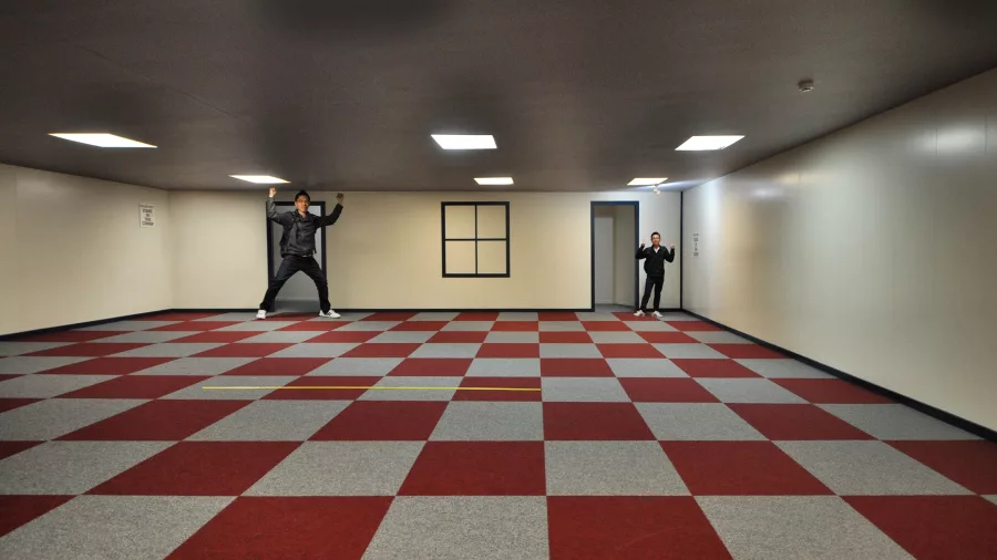 Ames Illusion Room at Puzzling World in Wānaka showing a visual size distortion between two people