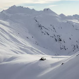 Snow-covered Whare Kea Mountain Chalet perched in the Southern Alps at 1,750 m in Mount Aspiring National Park