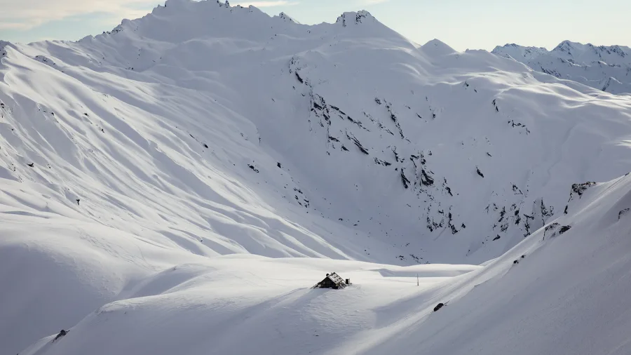 Snow-covered Whare Kea Mountain Chalet perched in the Southern Alps at 1,750 m in Mount Aspiring National Park