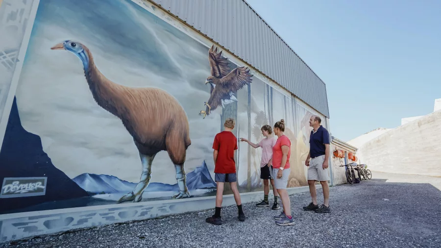 Family looking at moa and Haast's eagle mural in Bluff
