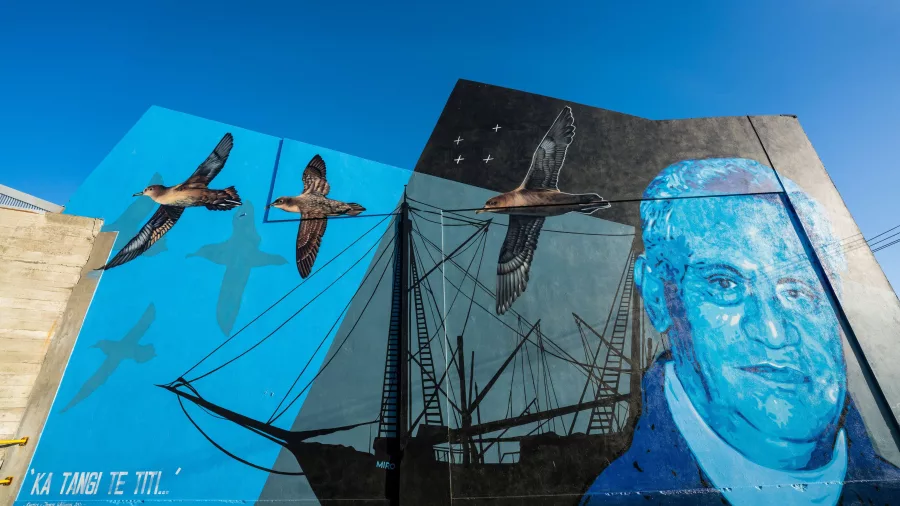 Ka Tangi Te Tītī mural featuring seabirds and historical figure in Bluff