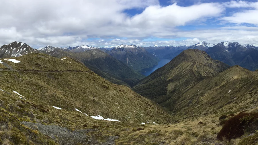 Alpine ridge view from the Kepler Track in Fiordland National Park overlooking Lake Te Anau and the snow-capped Southern Alps, South Island New Zealand
