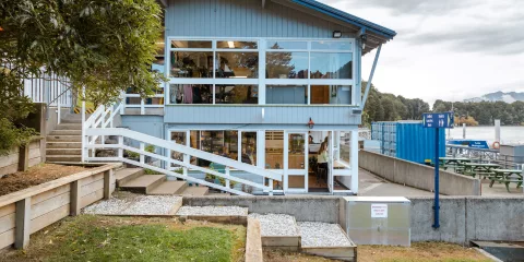 Manapouri Water Taxi office building near the lakefront, gateway to Fiordland adventures.