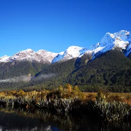 Snow-capped mountains reflected in Mirror Lakes, Fiordland National Park, New Zealand
