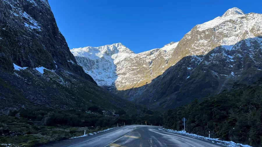 Snow-lined Milford Road approaching the Homer Tunnel in Southland, New Zealand