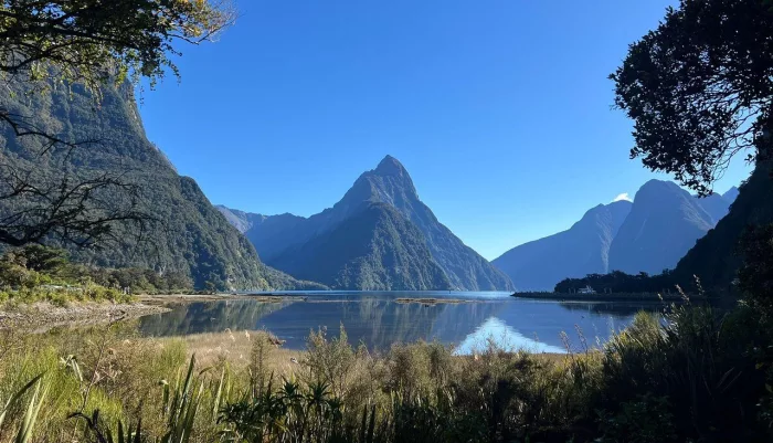 Calm morning reflection of Mitre Peak at Milford Sound Piopiotahi in Fiordland National Park, New Zealand