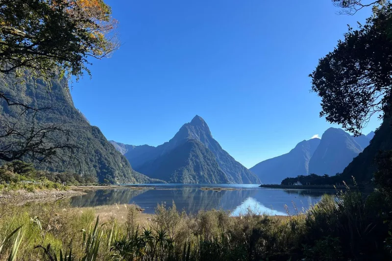 Calm morning reflection of Mitre Peak at Milford Sound Piopiotahi in Fiordland National Park, New Zealand