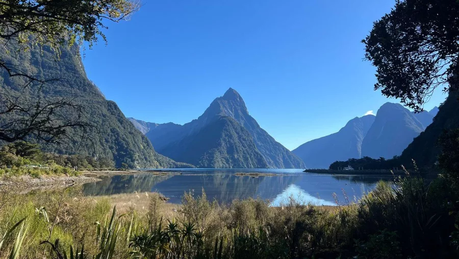 Calm morning reflection of Mitre Peak at Milford Sound Piopiotahi in Fiordland National Park, New Zealand