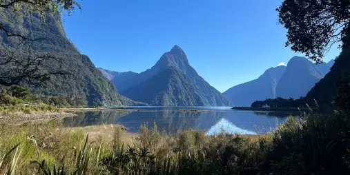 Calm morning reflection of Mitre Peak at Milford Sound Piopiotahi in Fiordland National Park, New Zealand