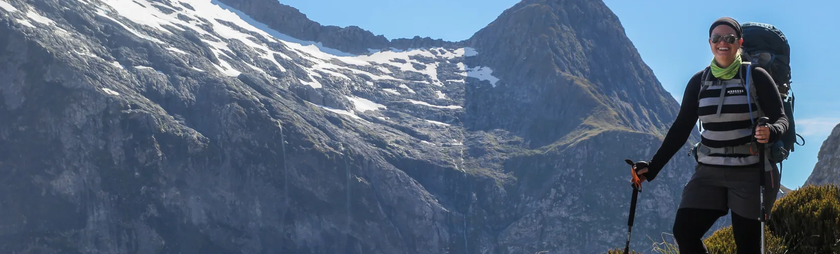 Hiker enjoying mountain views on the Milford Track, Southland New Zealand