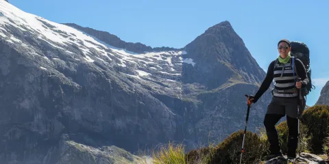 Hiker enjoying mountain views on the Milford Track, Southland New Zealand