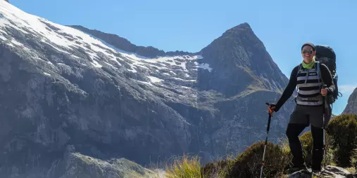Hiker enjoying mountain views on the Milford Track, Southland New Zealand