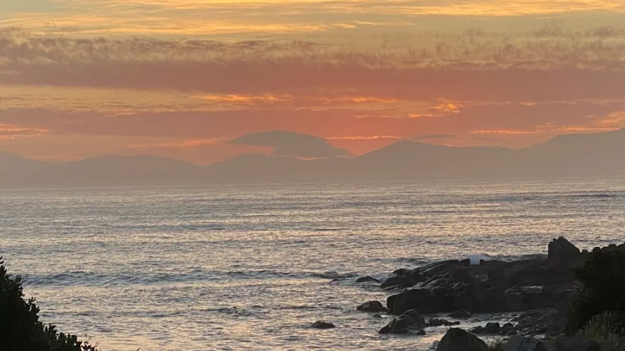 Golden sunset over Foveaux Strait, seen from the Bluff coastline in Southland, New Zealand.