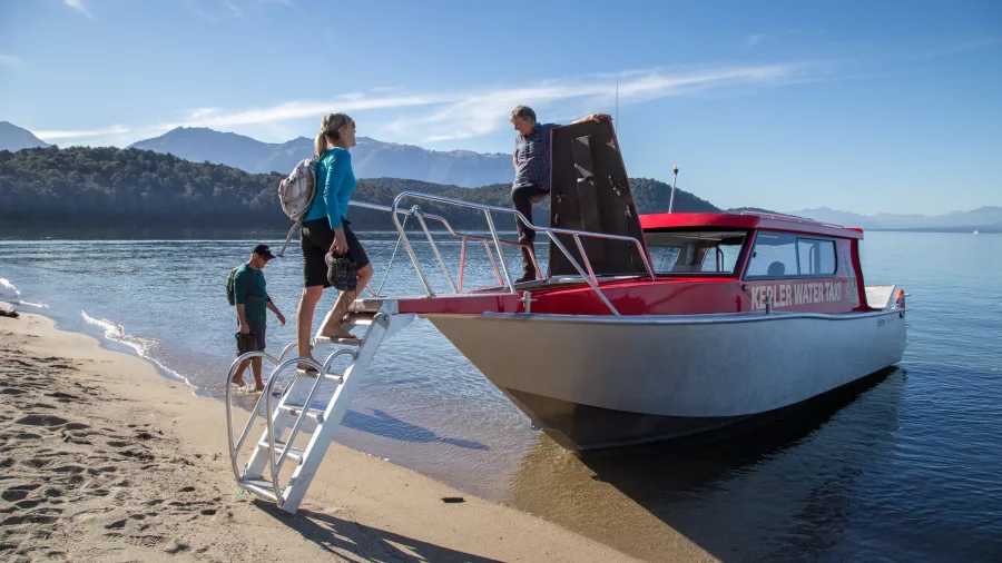 Walkers boarding the water taxi at Brod Bay to begin the Kepler Track day walk.