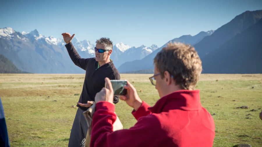 Guide explaining Fiordland’s glacial history in Eglinton Valley with dramatic alpine views.